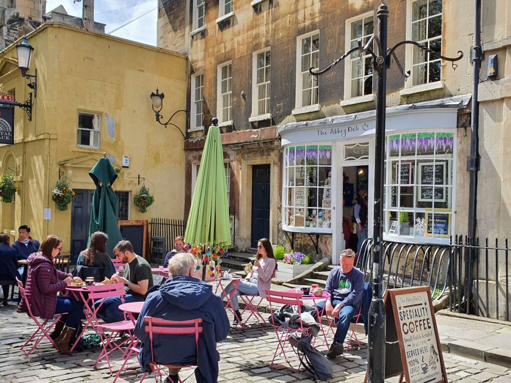 Busy cafe tables outside the Abbey Deli, Bath