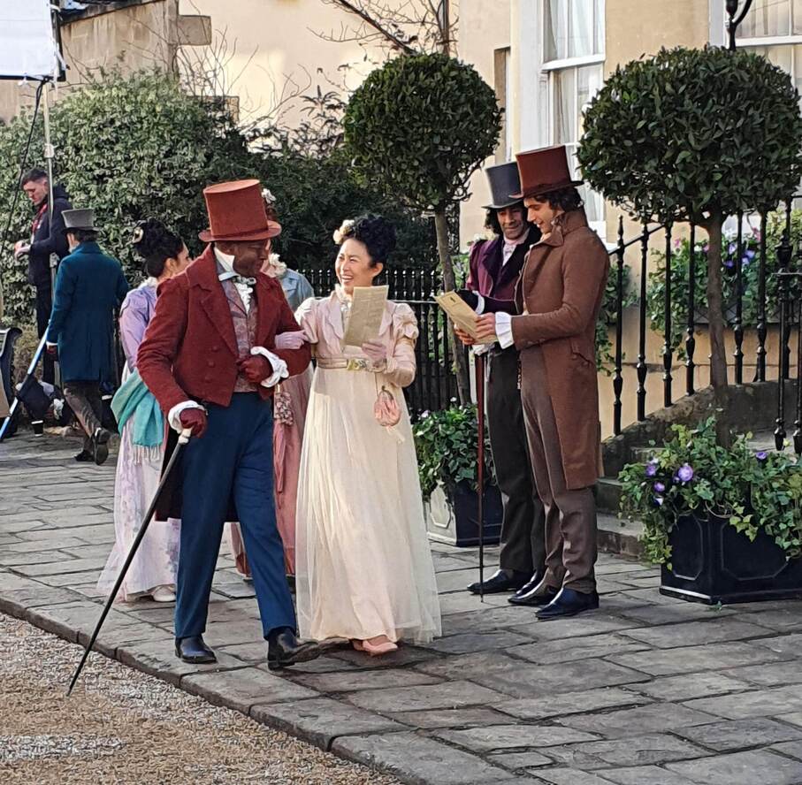 Bridgerton filming: costumed actors strolling in Bath - inspiration for a Bridgerton brerak